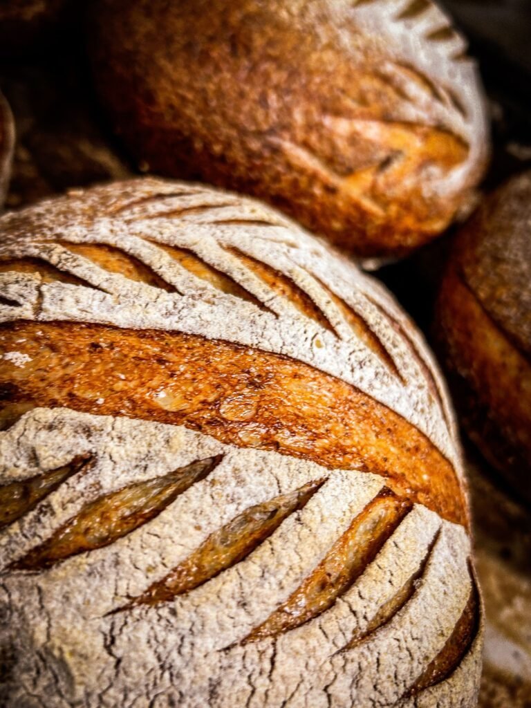 Scored artisan sourdough bread loaves fresh from the oven