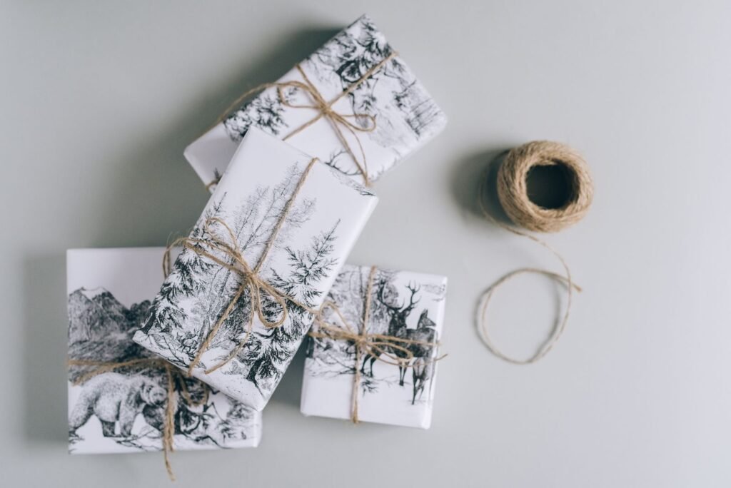 Christmas gifts wrapped in black and white paper tied with twine