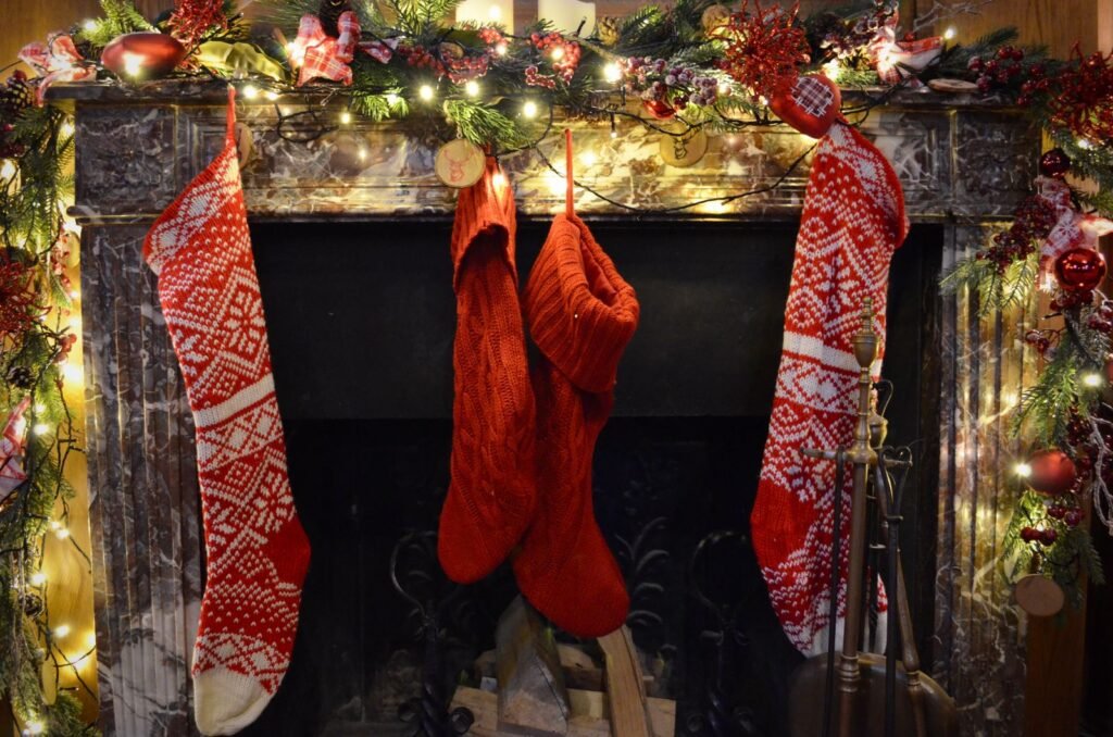 Festively decorated fireplace with Christmas stockings and twinkling lights, capturing holiday spirit
