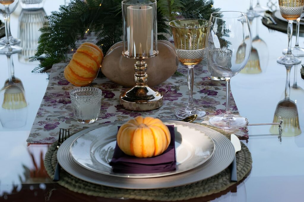 Autumn-themed table setting with pumpkins and elegant glassware for festive dining