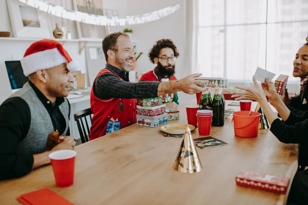Joyful Christmas party with friends exchanging gifts indoors, creating holiday cheer