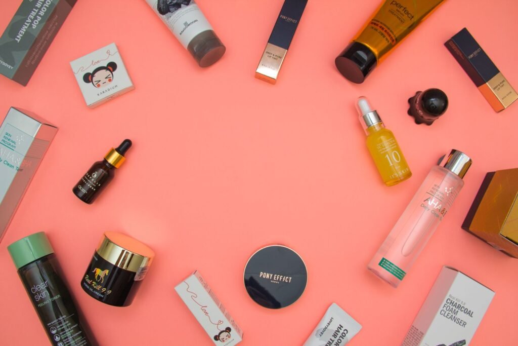 Top view of various skincare and beauty products in bottles on a surface